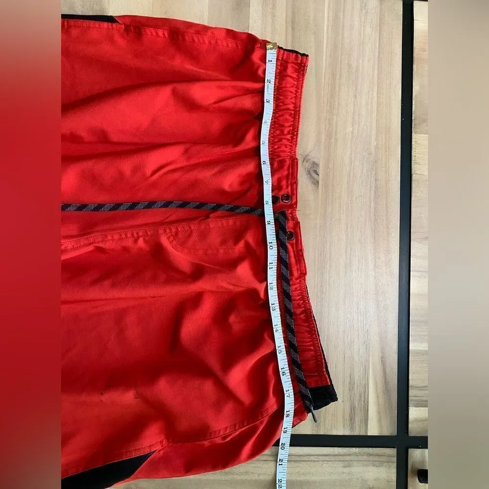 Red and black Nike swim trunks‎